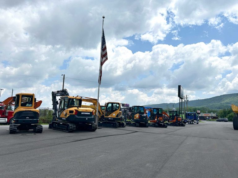 Shot of heavy equipment and tracey road sign with blue cloudy skies