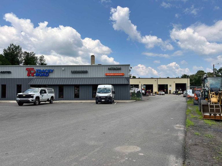 Industrial building with vehicles outside.